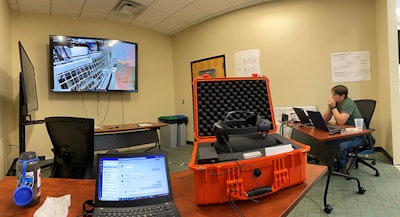 A member of the biodevices installation team in Durham, N.C. looks on as the Argentina-based hatchery customer conducts virtual installation procedures for the Embrex Inovoject NXT. (Zoetis)