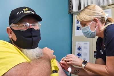 Hazeldene's employee Greg Exon receives his COVID-19 vaccination. (Bendigo Health)