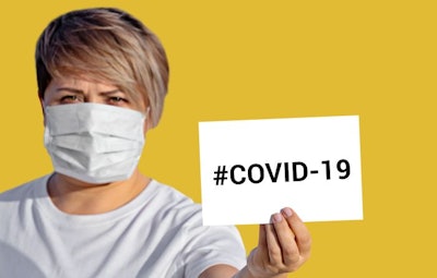 Woman in face mask hold blank with inscription COVID-19. World Health Organization WHO introduced new official name for Coronavirus disease named COVID-19