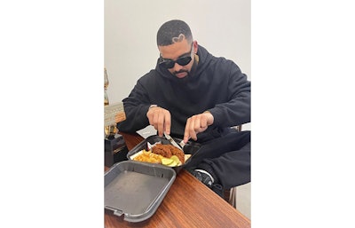 In May, Drake shared a photo of himself eating a to-go package of a Dave’s Hot Chicken combo on his Instagram story. (Instagram)