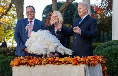 National Turkey Federation Chairman Phil Seger and Indiana turkey producer Andrea Welp present Peanut Butter, the 2021 National Thanksgiving Turkey, to President Joe Biden. (Courtesy of the White House)