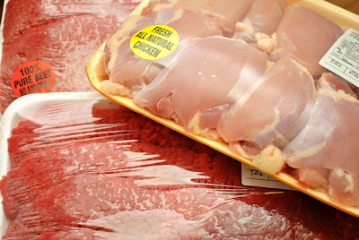 Packaged meat at the market; boneless chicken thighs and beef cube steaks..** Note: Shallow depth of field
