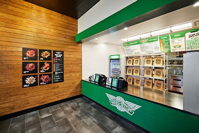 Entrance of Wingstop's ...restaurant of the future... - a digitally-focused prototype restaurant - designed around the carryout guest and delivery driver.