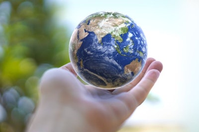 Human hand holds small Earth with care and love. Planet Earth globe ball in human hand. Strong Human hands support planet. Earth day and saving planet. Environment conservation concept.