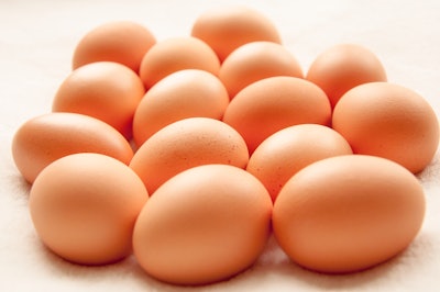 A group of Brown hens eggs on a white background