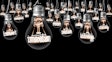 Large group of light bulbs with shining fibers in a shape of INNOVATION and IDEA concept related words isolated on black background; horizontal composition