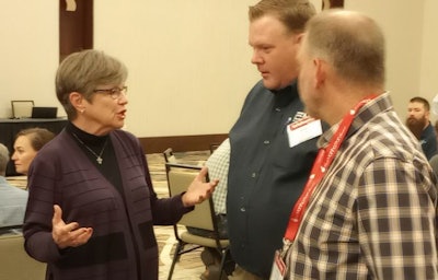 Kansas Gov. Laura Kelly, left, visits with Cal-Maine Foods officials at the Kansas Ag Summit on August 18. (Roy Graber)