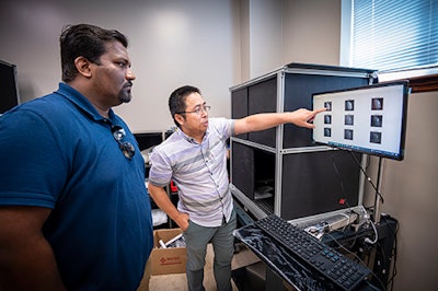 Anuraj Sukumaran (left), assistant professor in the Mississippi State Department of Poultry Science, and Yuzhen Lu, assistant professor in the MSU Department of Agricultural and Biological Engineering, study imaging technology that detects subsurface defects in poultry. (David Ammon)