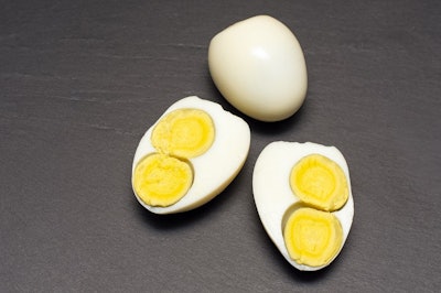 egg with two yolks on a black background.