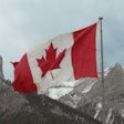 Canada Flag In Mountains