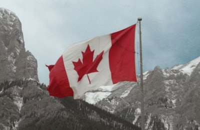 Canada Flag In Mountains
