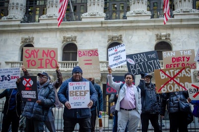 Members of the advocacy group Ban the Batistas protest outside of the New York Stock Exchange office on April 26, the same date JBS shareholders elected brothers Wesley and Joesley Batista to the board.