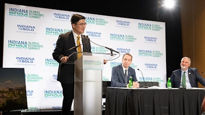 Purdue President Mung Chiang, alongside Indiana Gov. Eric Holcomb (right) and Elanco CEO Jeffrey Simmons (center), discusses the new One Health Innovation District during the announcement at the Indiana Convention Center.